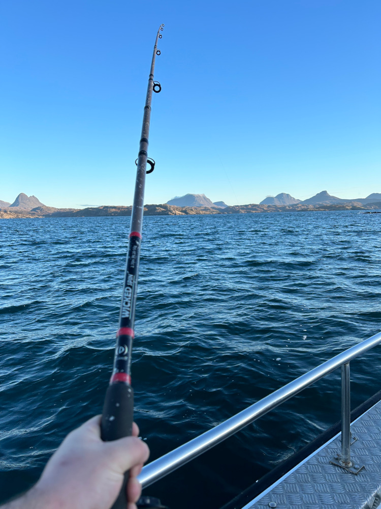 fishing in the backdrop of the mountains